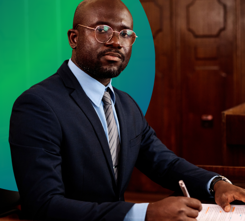 Bald man with glasses and suit at desk with pen and paper solicitor commercial property surveyor CCA check challenge appeal